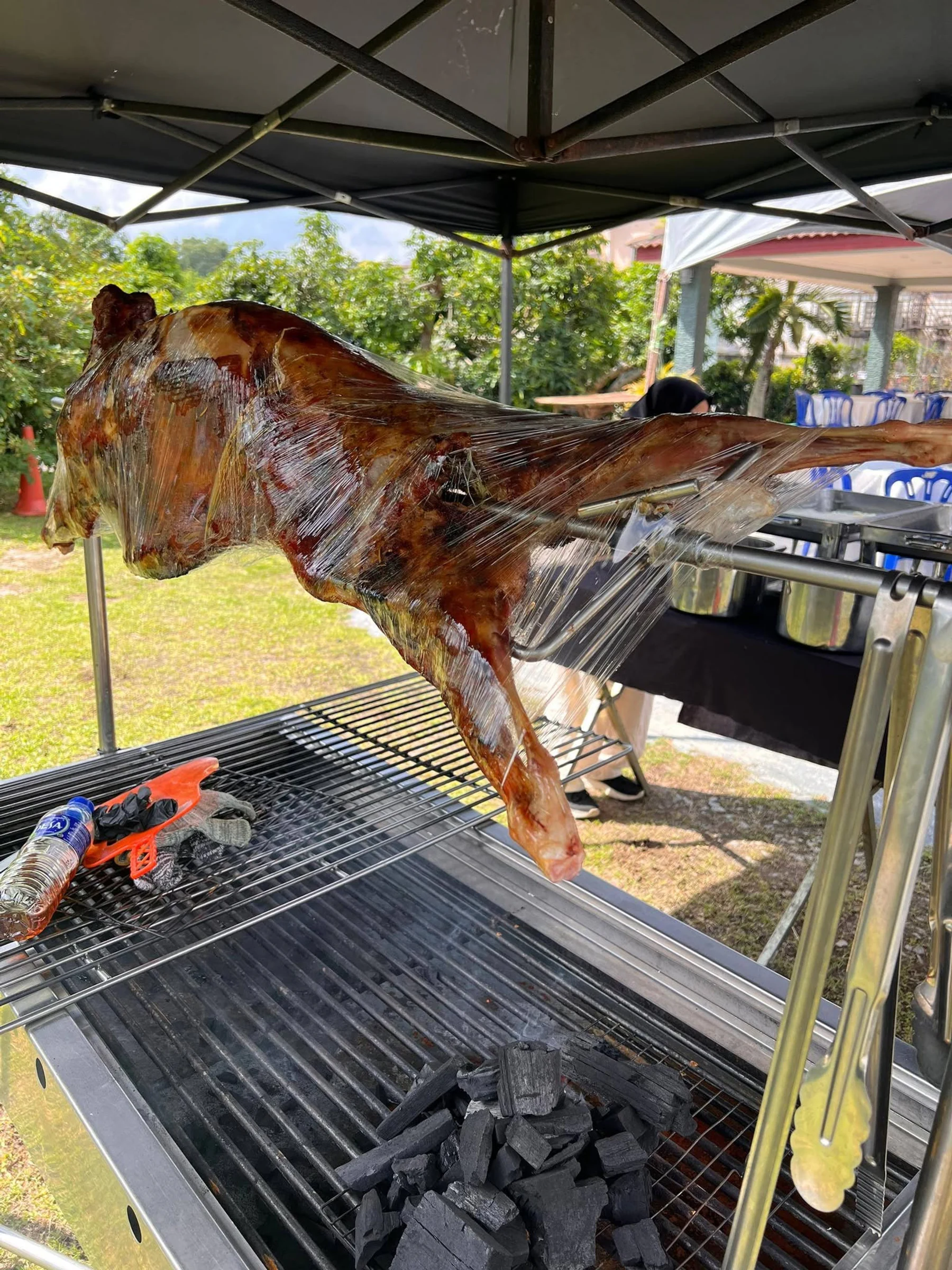 Kambing golek dibakar perlahan di kawasan terbuka